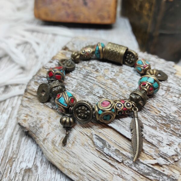 Photo d'un bracelet artisanal et ethnique d'inspiration tibétaine, fait à partir de pierres semi-précieuses de corail et de turquoise.