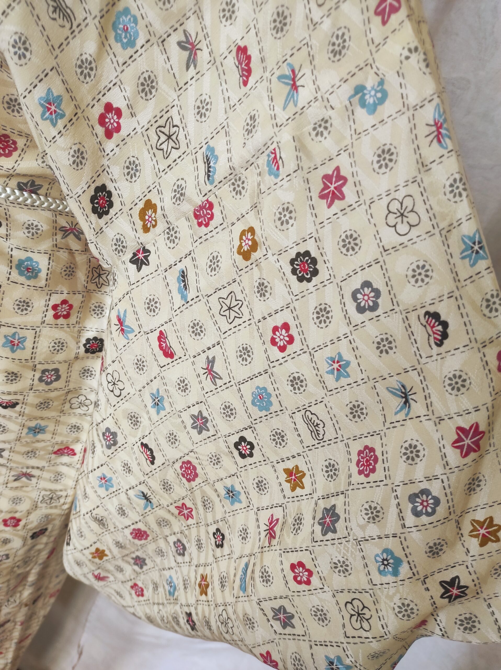 Image rapprochée des motifs de blasons familiaux traditionnels faits par tampon sur un kimono en soie