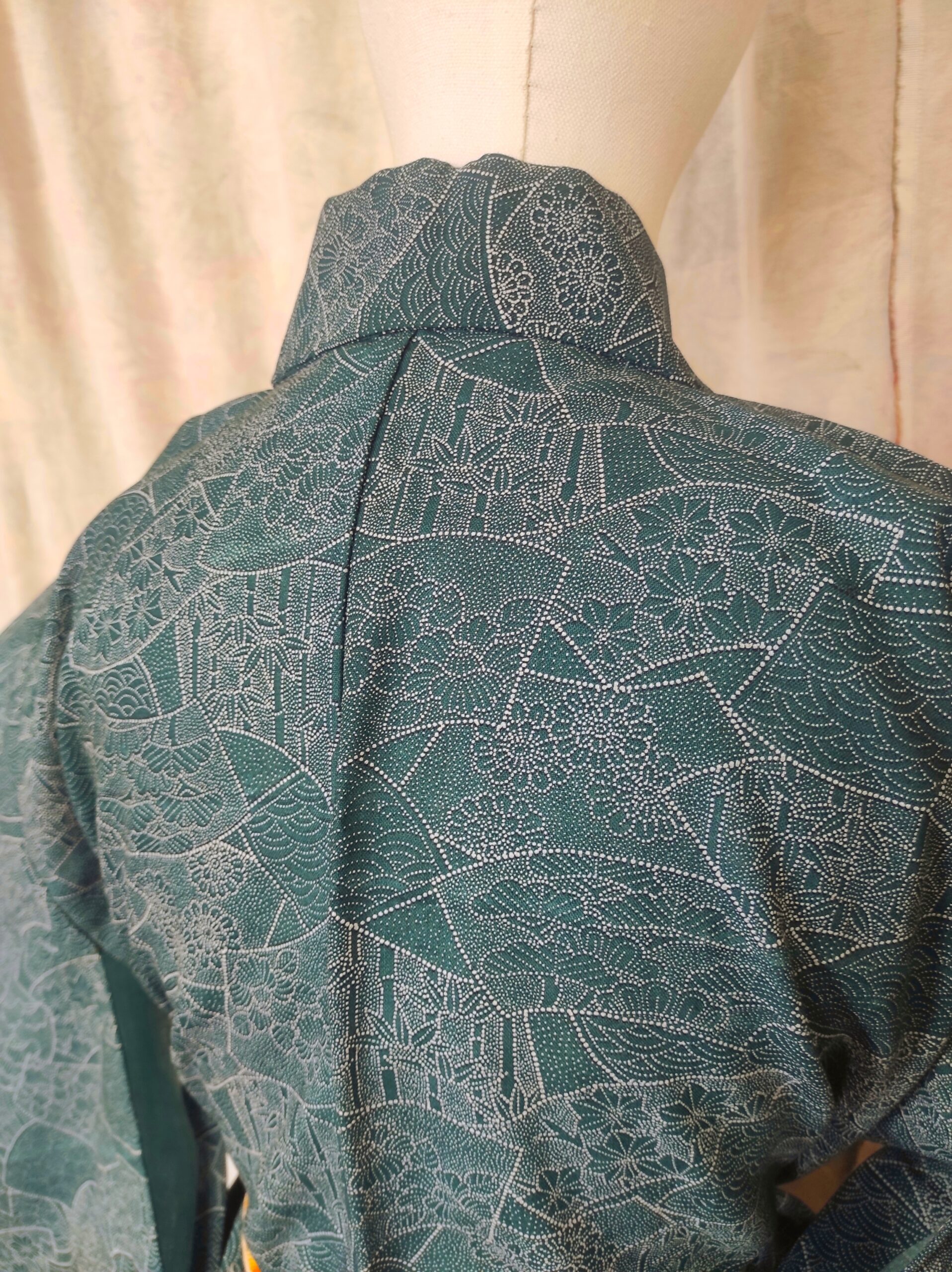 Photographie du dos d'un kimono japonais vintage en laine bleue et de ses motifs traditionnels nippons
