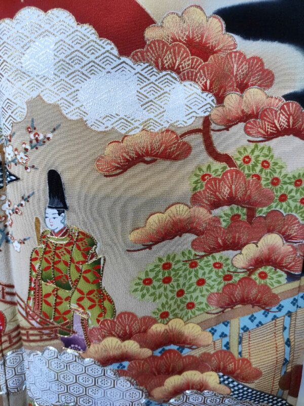 Photographie rapprochée de peinture sur soie de kimono représentant un religieux, des pins japonais, des nuages
